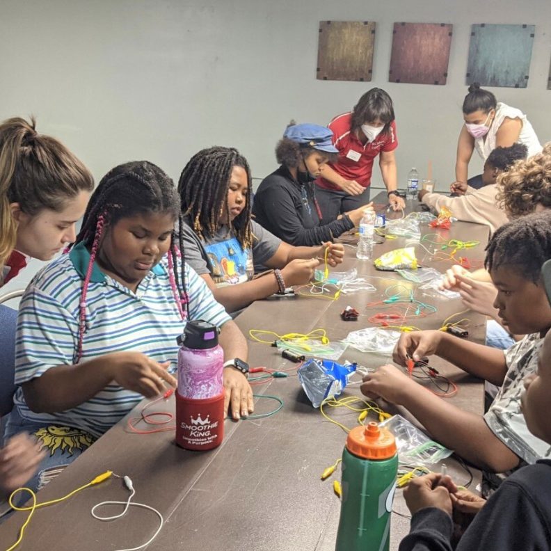 Communiversity scholars take part in an electrical engineering activity, building circuits, with staff from The Engineering Place via N.C. State's College of Engineering.