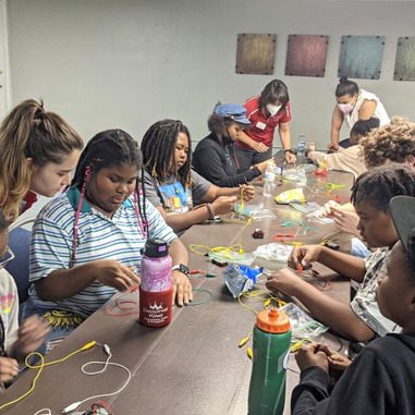 Communiversity scholars take part in an electrical engineering activity, building circuits, with staff from The Engineering Place via N.C. State's College of Engineering.